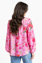 Rear of Women wearing a pink floral blouse