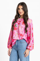 Women wearing a pink floral blouse