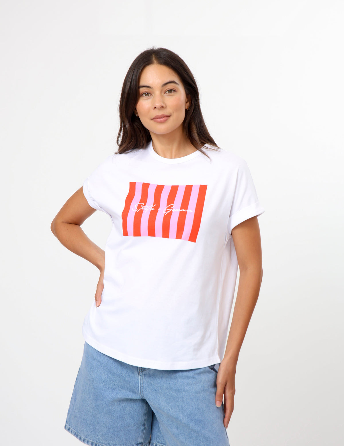 A women wearing a white short sleeve tee with a pink candy coloured print on the front