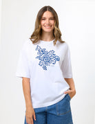women wearing a white tee with a blue floral pattern.