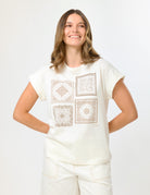 Women wearing a short sleeved t-shirt with a tile pattern printed on the front