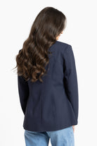 Person wearing a navy blazer from behind on a white background