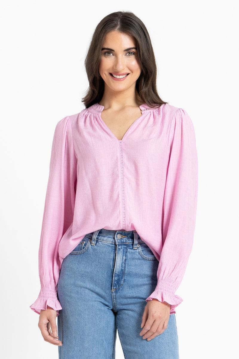 Woman wearing pink blouse