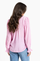 Rear of Woman wearing pink blouse