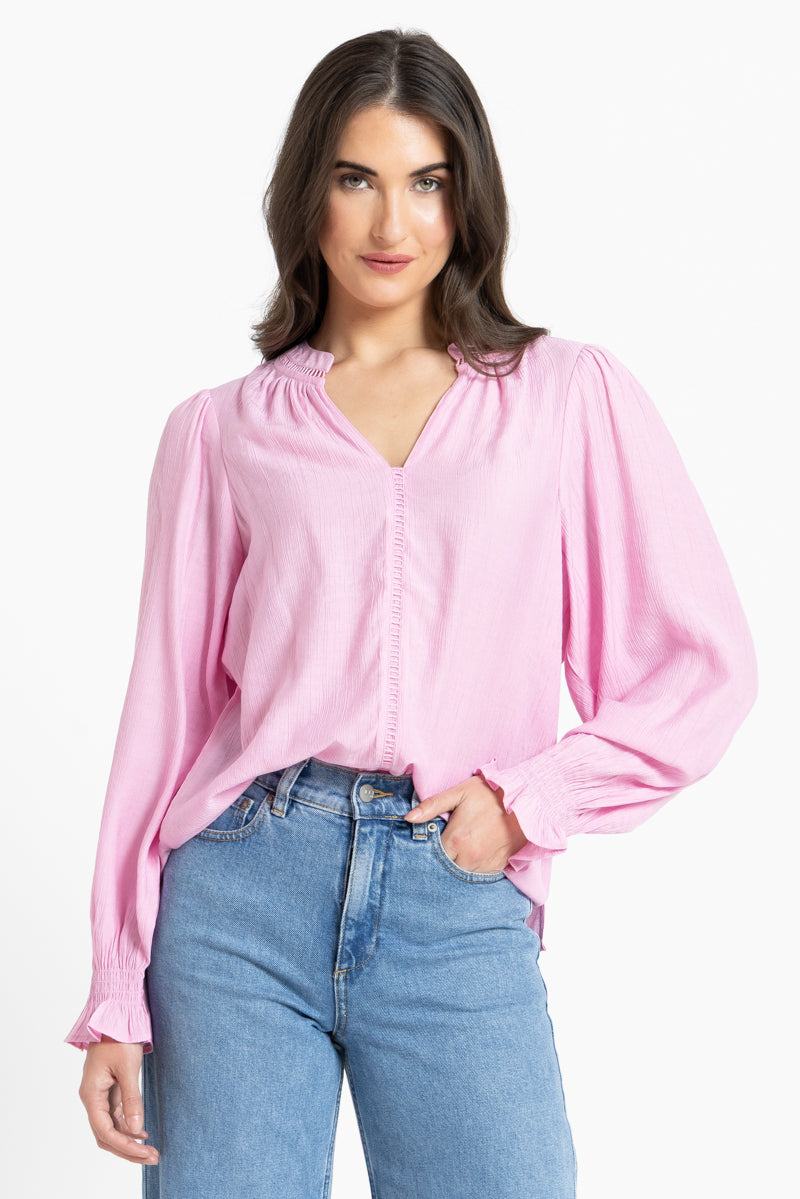 Woman wearing pink blouse