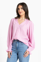 Woman wearing pink blouse