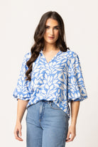 Women wearing a blue floral patterned blouse.