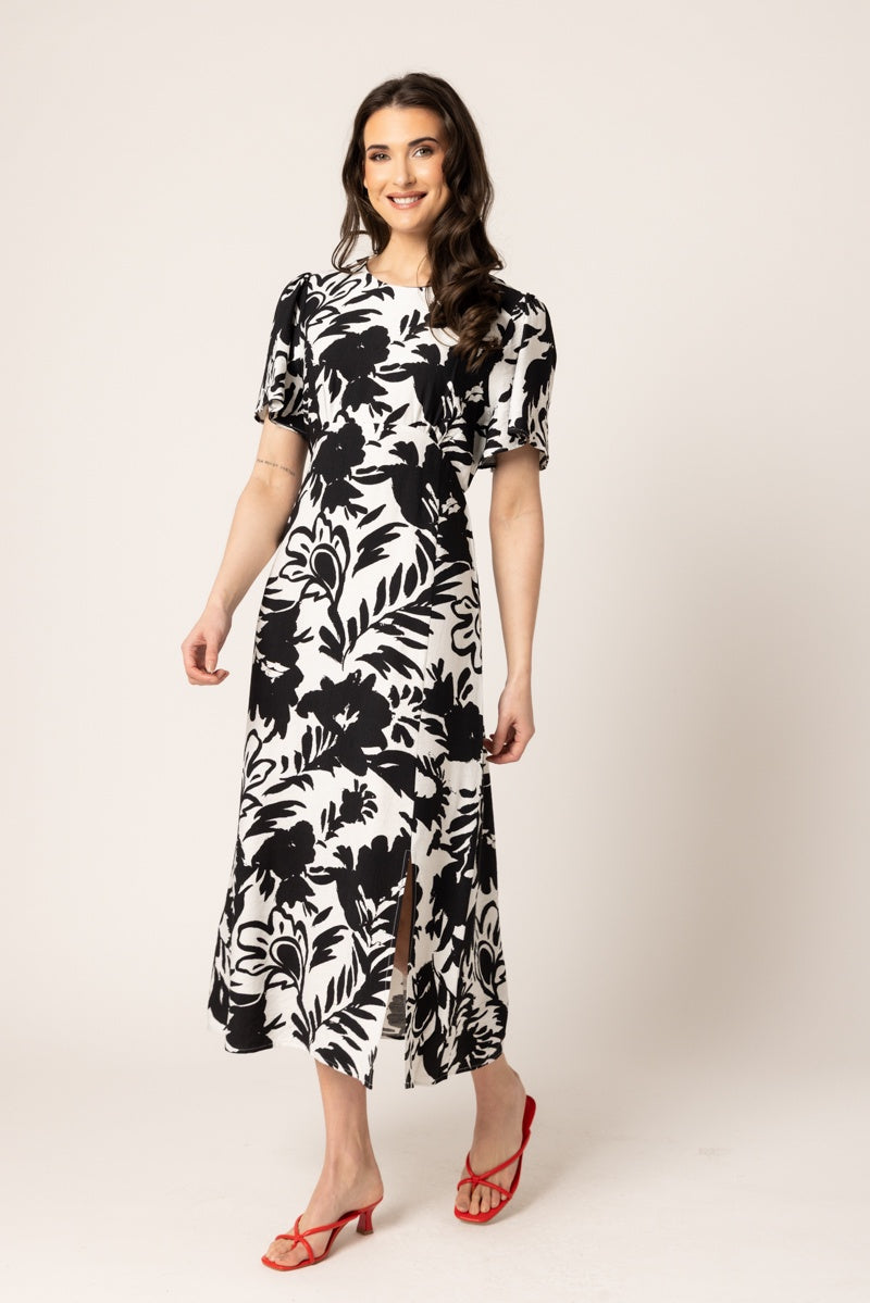 Women wearing long dress with black floral print