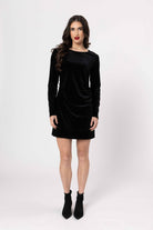 Woman wearing a black dress on a white background