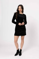 Woman wearing a black dress on a white background