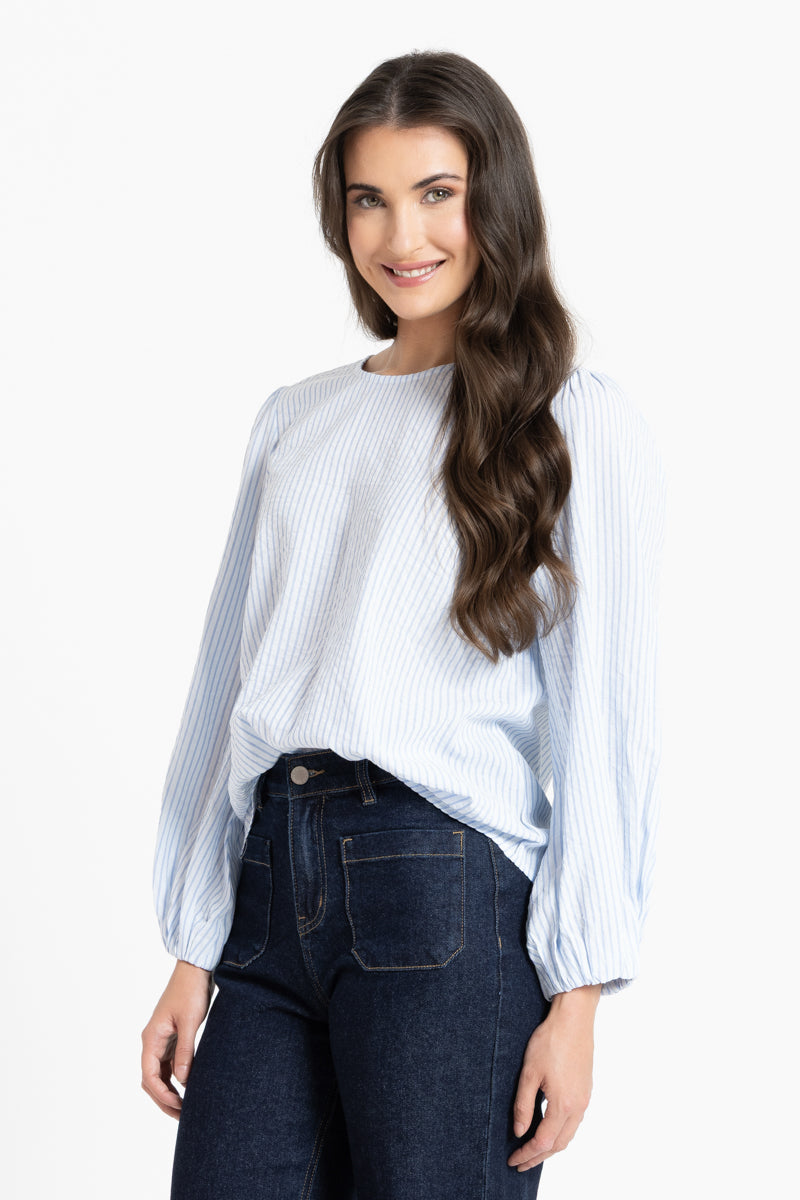 Woman wearing a white and blue stripe blouse