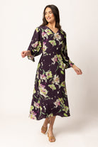 Women wearing a purple floral dress
