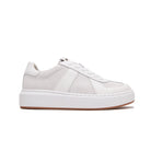 A low-top platform sneaker in white and light gray suede and leather, featuring a thick white sole and a gum brown outsole, shown from a side profile on a white background.