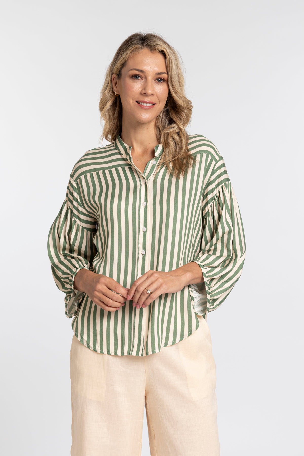 Women wearing green and cream strip shirt.